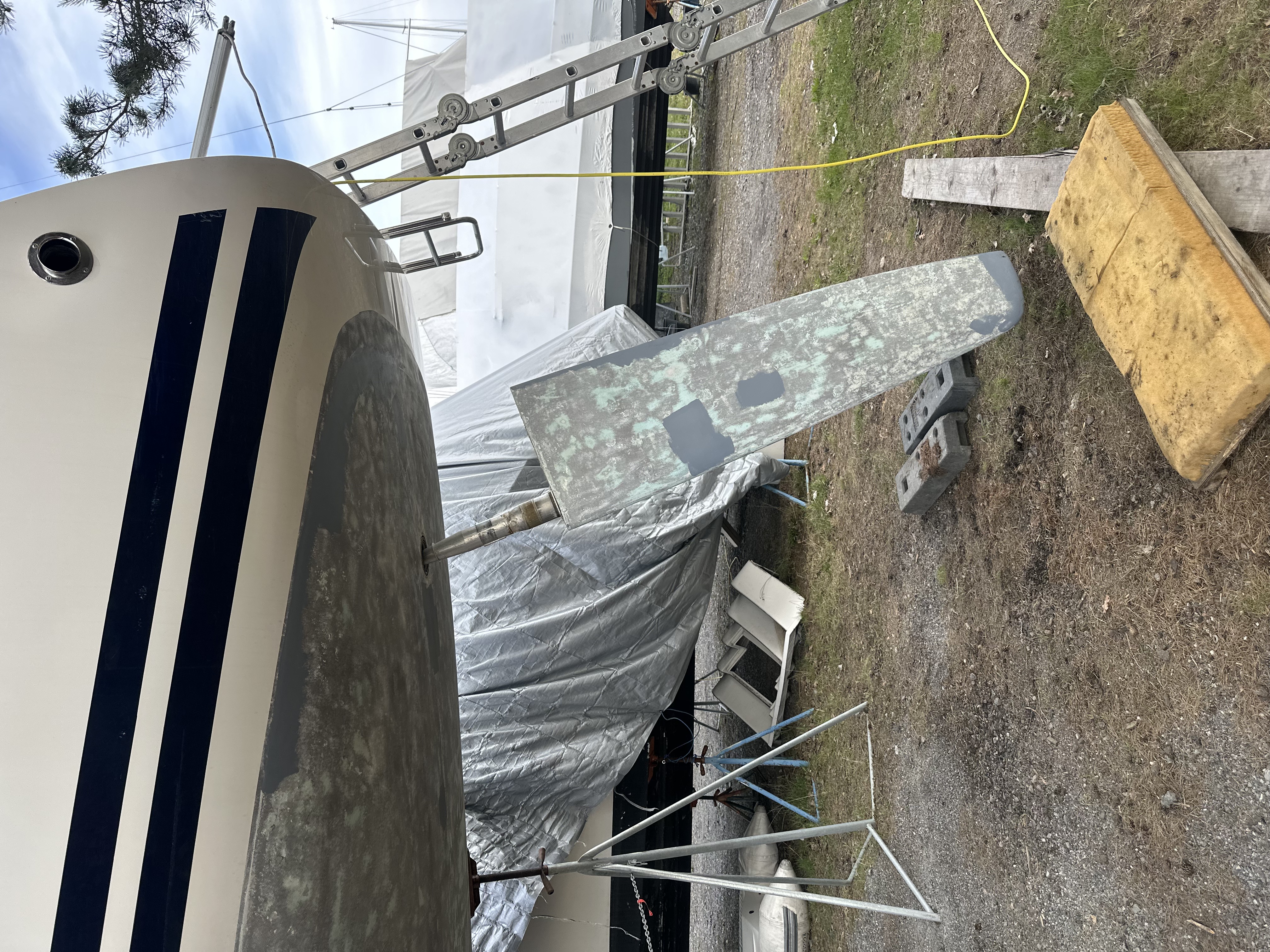 The rudder off, showing the old paint and damage